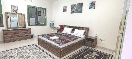 a bedroom with a bed and a phone in it at Dragon Golden Apartment 2 in Dubai