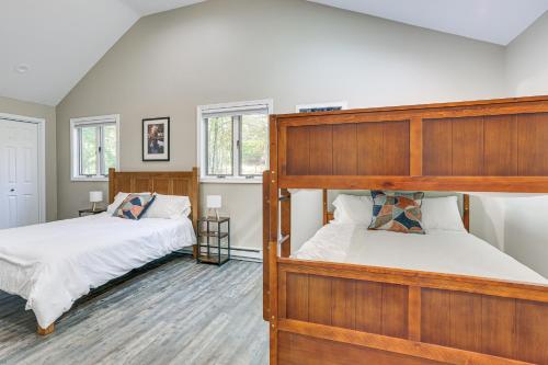 a bedroom with two bunk beds and two windows at 6 Mi to Bushkill Falls Secluded Home with Game Room in Saw Creek