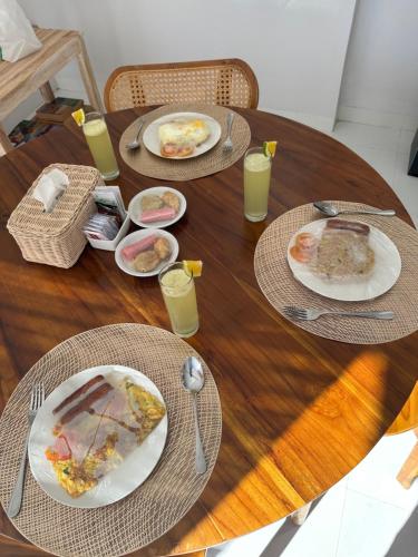 a wooden table with plates of food on it at Amed Happy House in Amed