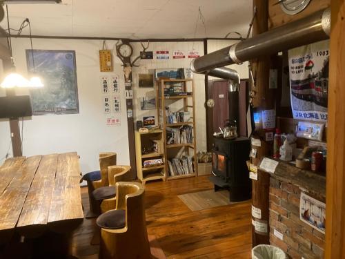 a dining room with a wooden table and chairs at Ekinoyado Hirafu in Kutchan