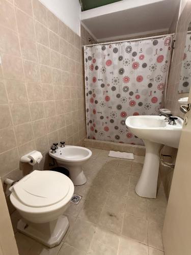 a bathroom with a toilet and a sink at Hotel Montecarlo PSH in Villa Carlos Paz