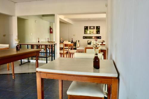 a living room with a table and some chairs at Hotel Montecarlo PSH in Villa Carlos Paz