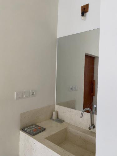 a bathroom with a sink and a mirror at Mango Room Mandalika in Kuta Lombok