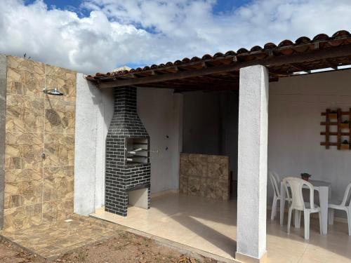 a patio with a brick fireplace on a house at Aconchego do sertão in Piranhas