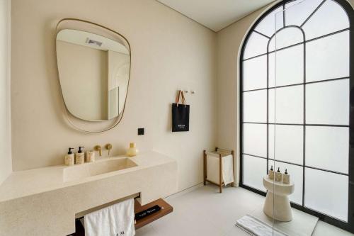 a bathroom with a sink and a mirror at Parisian Brand New Luxury Villa 8mins walk to Beach in Bingin Beach