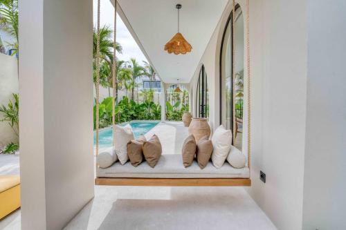 a living room with a bed and a swimming pool at Parisian Brand New Luxury Villa 8mins walk to Beach in Bingin Beach