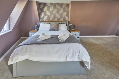 a bedroom with a large bed with towels on it at Opp Sally Lunns Sleeps 10 Spacious Maisonette in Bath
