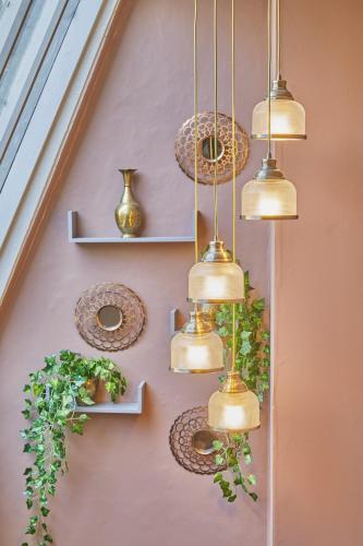 a bunch of pendant lights hanging from a wall at Opp Sally Lunns Sleeps 10 Spacious Maisonette in Bath