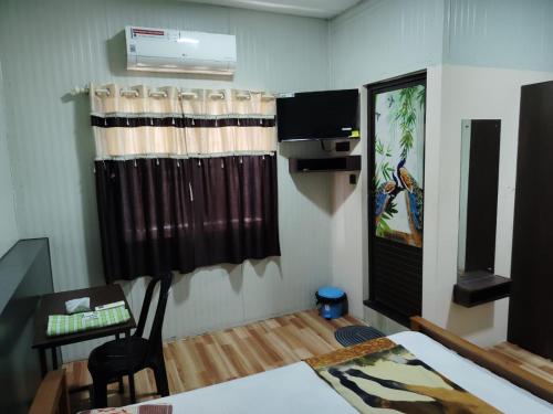 a room with a dining table and a room with a table and a window at Vidara Budget Stay in Trivandrum