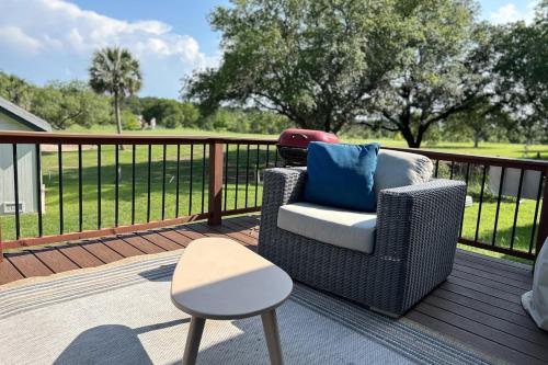 a wicker chair and stool on a deck at 5 minute walk to the gulf course in San Antonio