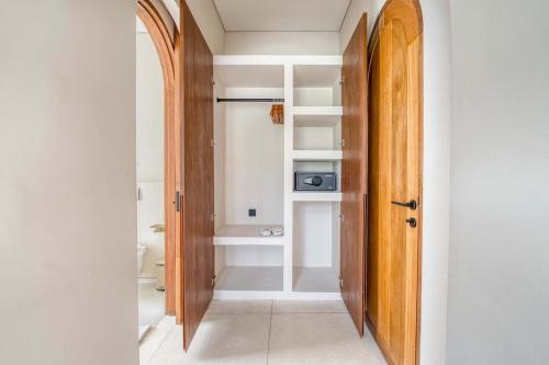 a hallway with a door leading to a bathroom at Parisian New 2BR Luxury Villa 8mins walk to Beach in Bingin Beach