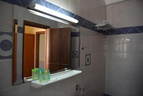 a bathroom with a sink and a mirror at Blue Sea Hotel in Mytilini