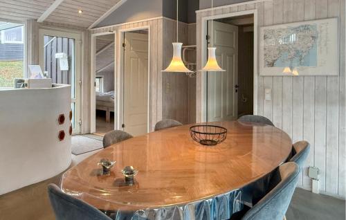 a dining room with a wooden table and chairs at Amazing Home In Ebeltoft With Sauna in Ebeltoft