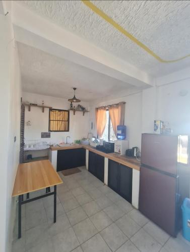 a kitchen with a refrigerator and a table in it at White beach Villa in Panglao Island