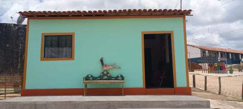 a colorful building with a door in a street at Casa Menezes - Ilha do Ferro - Alagoas in Pão de Açúcar