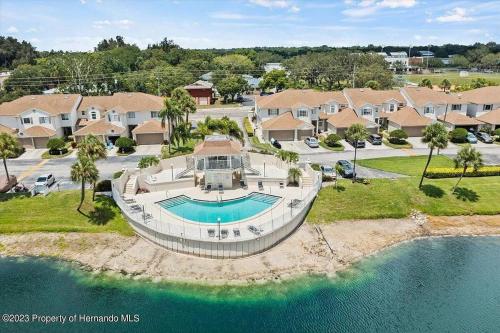 an aerial view of a house with a swimming pool at Sunset Palm Stay - Cozy Retreat Near Gulf Beaches in St. Petersburg