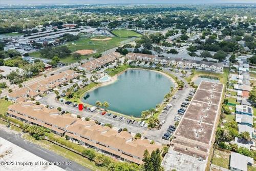 an aerial view of a park with a large pond at Sunset Palm Stay - Cozy Retreat Near Gulf Beaches in St. Petersburg