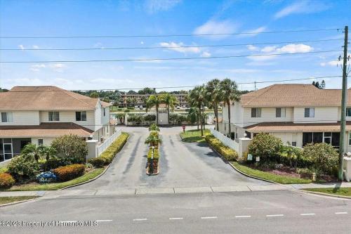 an empty street in a residential neighborhood with houses at Sunset Palm Stay - Cozy Retreat Near Gulf Beaches in St. Petersburg