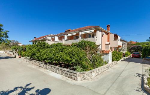 a house on the side of a street at Apartments and Rooms Dobrila in Jelsa