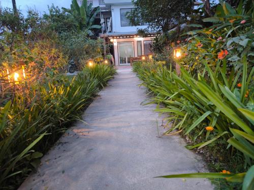 a pathway leading to a house at night with lights at Vang Vieng Champa Resort in Vang Vieng
