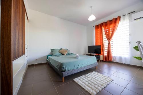 En eller flere senge i et værelse på Ambre - destination Guyane