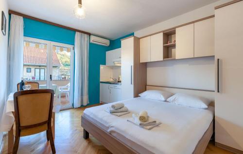 a bedroom with a bed with a chair and a window at Apartments and Rooms Dobrila in Jelsa