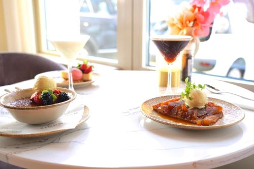 a table with two plates of food and two drinks at Hotel Alkmaar - Bar & Restaurant in Alkmaar