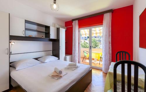 a bedroom with a bed with a red wall at Apartments and Rooms Dobrila in Jelsa