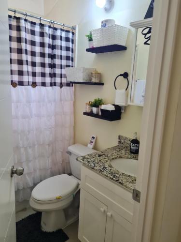 a bathroom with a toilet and a sink at Home to Comfort in Old Harbour