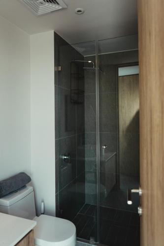 a bathroom with a toilet and a glass shower at Centro Zapopan in Guadalajara