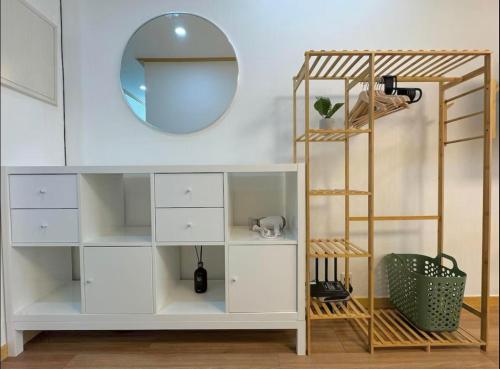 a room with a white shelf and a mirror at Hongdae sub 1min in Seoul