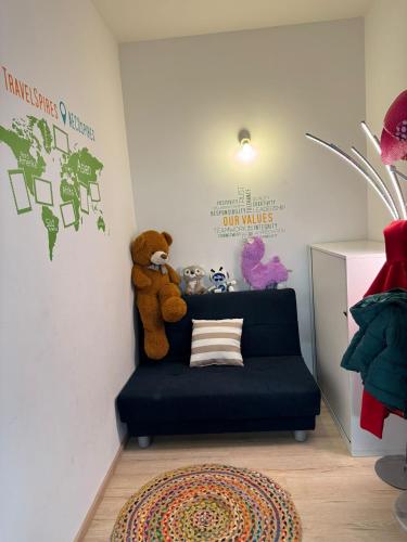 a childs room with a blue couch and teddy bears at AECOspires CoWorkStel in Munich