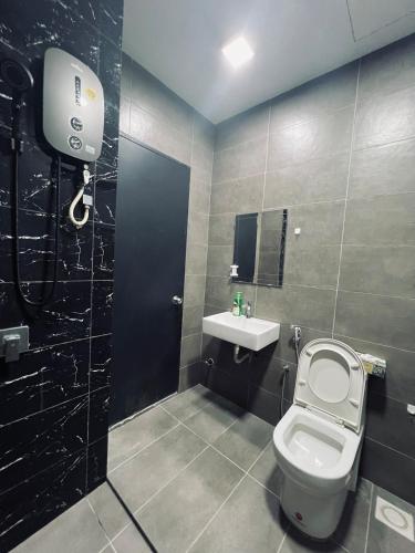 a bathroom with a toilet and a sink at Spacious 3B3R Unit in BukitJalil in Kuala Lumpur