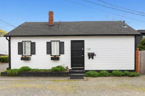 a white house with a black door at Downtown location Near the Beach Dog Friendly in Edmonds