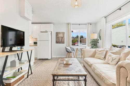 a white living room with a couch and a refrigerator at Downtown location Near the Beach Dog Friendly in Edmonds