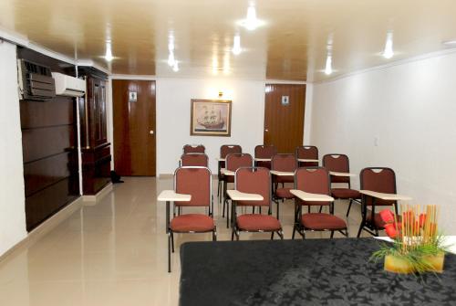 a conference room with a table and chairs in it at Caravelle Palace Hotel in Curitiba