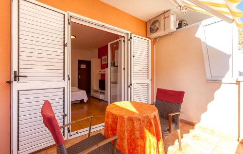 a dining room with a table and chairs and a window at Apartments and Rooms Dobrila in Jelsa
