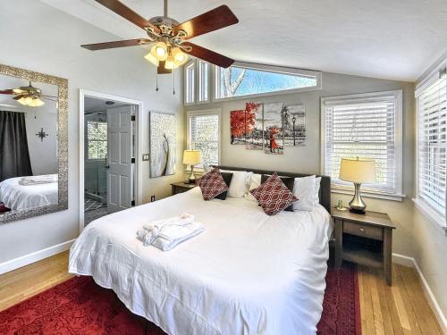 a bedroom with a large white bed with a ceiling fan at 826 Wilson Road in Highlands