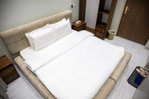 a large bed with white sheets and pillows in a room at aroya in Jeddah