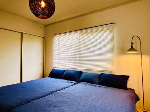 Ένα ή περισσότερα κρεβάτια σε δωμάτιο στο 江の島ハウス