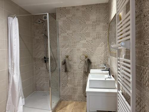 a bathroom with a shower and two sinks and a shower at Gîte paisible dans château avec jardin en Auvergne - FR-1-489-604 in Louchy-Montfand