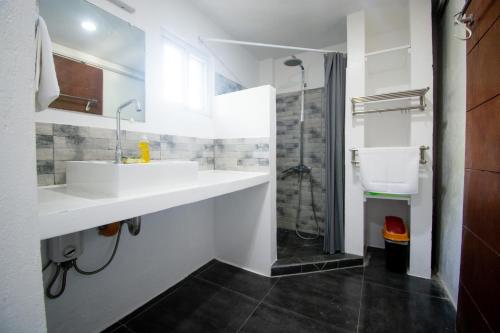 a bathroom with two sinks and a shower at BABOSAM Hotel in Boracay