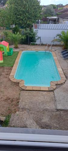 a swimming pool in a yard with a playground at Casa Ginguba in Saint-Émilion
