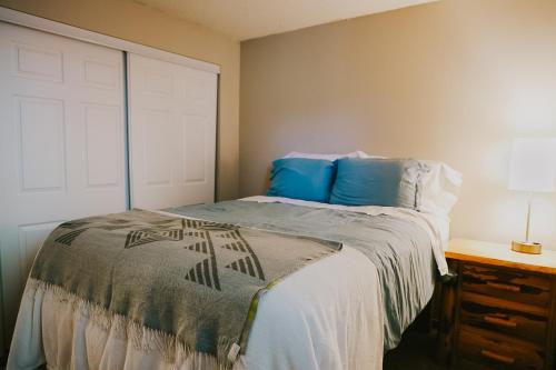 a bedroom with a bed with blue pillows at Breck Ski Chalet, Pet Friendly, Private Hot Tub and Scenic Views in Breckenridge