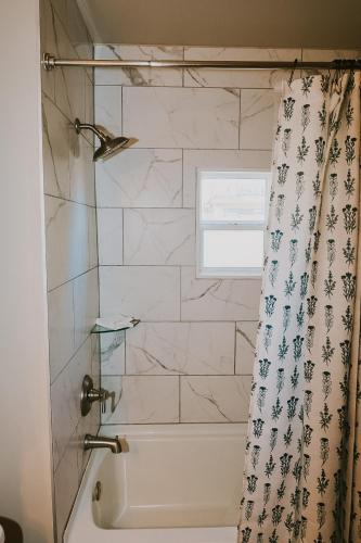 a bathroom with a tub and a shower curtain at Breck Ski Chalet, Pet Friendly, Private Hot Tub and Scenic Views in Breckenridge