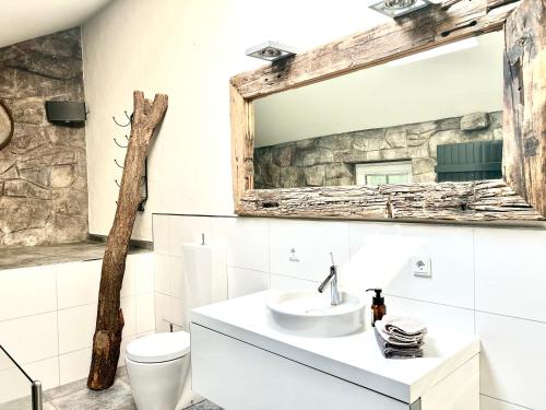a bathroom with a sink and a mirror at Bramasole - Wohnung mit Carport in Cottbus