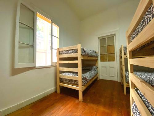 a room with two bunk beds and a window at La Mancha Art Hostel in Valparaíso