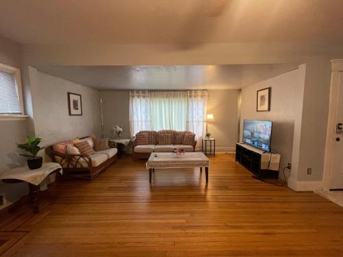 a living room with a couch and a table at Buffalo 4BR Home 5 Beds, Near Airport & Downtown in Buffalo
