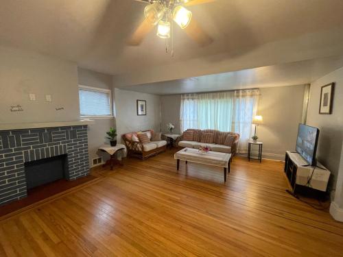 a living room with a couch and a fireplace at Buffalo 4BR Home 5 Beds, Near Airport & Downtown in Buffalo