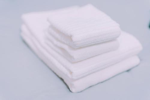 a pile of white towels stacked on top of each other at Stylish Minimalist Loft 7 & Gym in Namba Compact Studio 5 in Wada